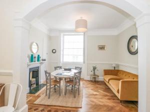 a living room with a table and a couch at The Westgate in Bridport