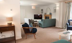 a living room with a couch and a chair at Brooklands in Lyme Regis