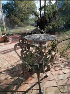 a wrought iron table sitting on a brick patio at Hoenerhok in Vanrhynsdorp