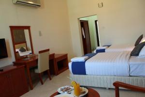 Postel nebo postele na pokoji v ubytování Al Jabal Hotel