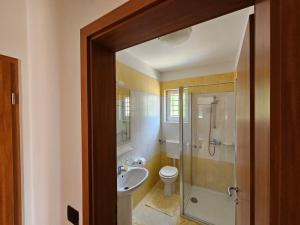 a bathroom with a toilet and a sink and a shower at Residence Gordana 2 in Selce +35 photos