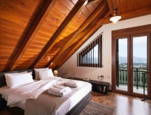 a bedroom with a large bed with wooden ceilings at Myron Olive Villa Retreat in Áyios Míron +41 photos