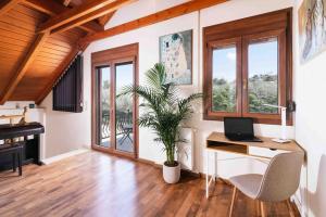 a home office with a desk and a laptop at Myron Olive Villa Retreat in Áyios Míron