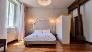 a bedroom with a bed in a room with a window at Locanda Al Volo Tommaseo in Trieste