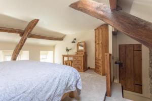 a bedroom with a large bed and wooden cabinets at Chapel Cottage with Log Burner (Dog Friendly) in Hawes