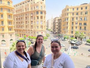 three women standing on top of a building at Cairo Inn in Cairo