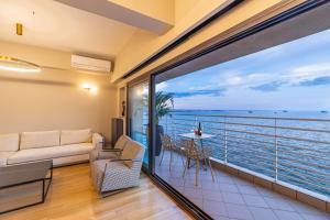 a living room with a view of the ocean at ICONIC SALONICA SUITE seafront in Thessaloniki