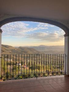 a balcony with a view of a mountain range at Apartamento La Fuente Alcaucin in Alcaucín