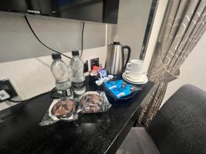 a table with bottles and other items on it at Great St Helen Hotel in London