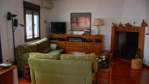 uma sala de estar com um sofá e uma lareira em Casa Rural Valle de los Molinos em El Cristo del Espíritu Santo