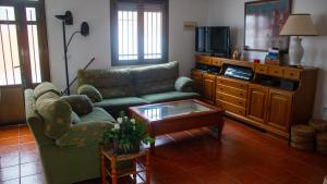 a living room with a couch and a coffee table at Casa Rural Valle de los Molinos in El Cristo del Espíritu Santo