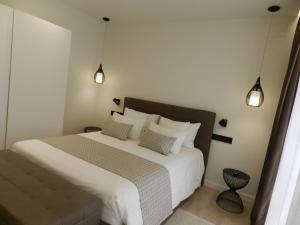a bedroom with a large white bed with two pillows at HOTEL MANEL in Martorell