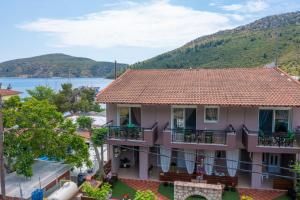 a house with a view of the water and mountains at Studios Diogenis in Porto Koufo