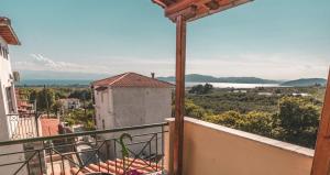 a balcony of a house with a view of the ocean at Pelion Charming Cottage, Panoramic Seaview Retreat in Volos