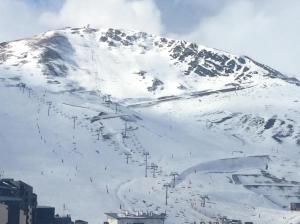 a snow covered mountain with a ski lift on it at Appartement 5 Pers Pieds des pistes in Saint-Lary-Soulan
