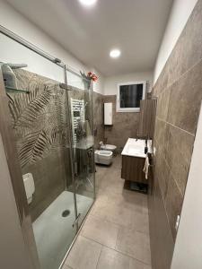 a bathroom with a shower and a toilet and a sink at A casa di Rosy in Casalecchio di Reno