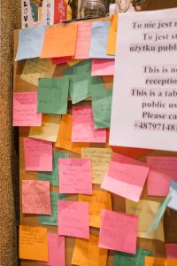 a pile of sticky notes on top of a table at Girls Hostel in Kraków