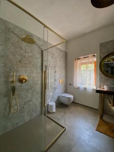 a bathroom with a glass shower and a toilet at Casal Camillo in Case Selva Grande