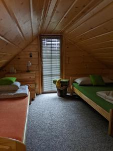 Habitación con 2 camas en una cabaña de madera en Góralski domek w Kluszkowcach, en Kluszkowce