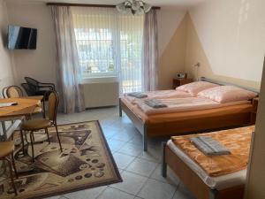 吉波瓦的住宿－Dom Wczasowy Mrokon，卧室配有两张床、一张桌子和一张桌子以及椅子。