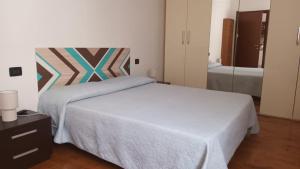 מיטה או מיטות בחדר ב-Casa Alessandra