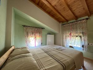 a large bed in a room with two windows at Escape to Paradise - Experience Luxury and Serenity at Villa Elina in Sithonia in Metókhion Ayías Kiriakís +48 photos