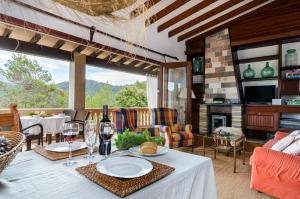 a dining room with a table with wine glasses at YourHouse Can Marquesi in Lluc