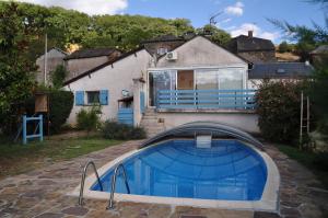 a house with a swimming pool in front of a house at CHEZ LUCIEN in Trébas