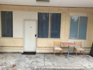 a table and two chairs in front of a building at Chadstone Holiday E2 Villa in Oakleigh