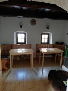 a room with two tables and two windows at Chyžka Stará Hora in Sebechleby