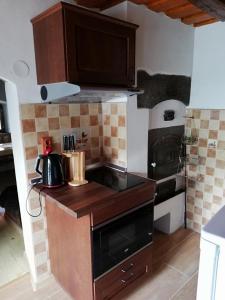 a kitchen with a stove and a counter top at Chyžka Stará Hora in Sebechleby