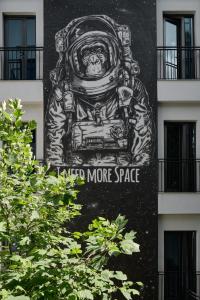 a mural on the side of a building at Sapiens Hotel in Tashkent