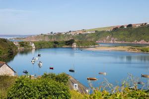 a large body of water with boats in it at White Horses a large family home in Bantham South Devon with fantastic sea views in Bigbury on Sea