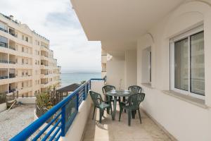 a balcony with a table and chairs and the ocean at Apartamento 305 in Marbella