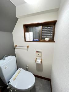 a bathroom with a toilet and a toilet paper dispenser at Japanese House-ueno/asakusa/oshiage/ginza/narita in Tokyo