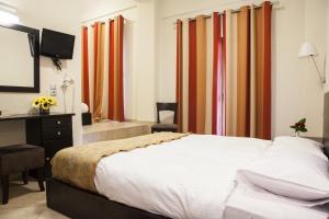 Postel nebo postele na pokoji v ubytování Hotel Meteoritis
