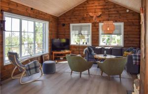 a living room with a couch and a table and chairs at 5 Bedroom Stunning Home In Passebekk in Omholt