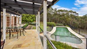 an outdoor deck with a swimming pool on a house at The Manor in Blue Mountains in Wentworth Falls