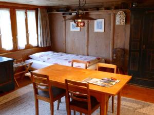 a room with a table and chairs and a bed at Landgasthof Tännler in Innertkirchen