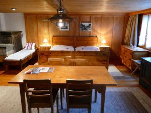 a room with a table and a bed and a bedroom at Landgasthof Tännler in Innertkirchen