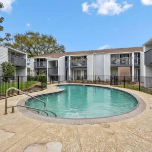 a swimming pool in front of a building at Royal Palm at Lake Conroe NO PARTIES NO SMOKING 1000k FINE in Montgomery