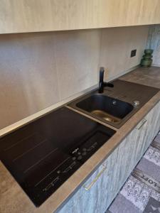 a kitchen counter with a sink and a stove at El Dorado Las Americas WiFi Pool in Arona