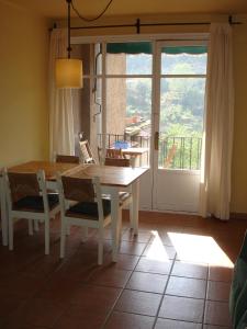 a dining room with a table and chairs and a window at APARTAMENTS PUIG GILI in Mura