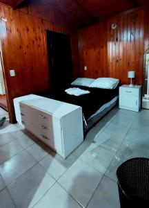 1 dormitorio con 1 cama y vestidor en Cabaña Jano en Posadas