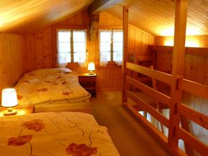 a bedroom with two beds in a cabin at Landgasthof Tännler in Innertkirchen