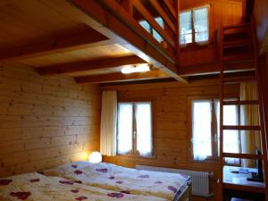 a bedroom with a bed in a wooden cabin at Landgasthof Tännler in Innertkirchen