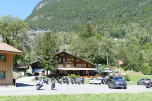 a group of people riding motorcycles in front of a building at Landgasthof Tännler in Innertkirchen