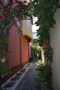 an alley with flowers and a building with a balcony at Casa Mara in Tulcea