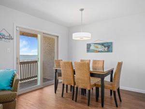 a dining room with a table and chairs at Bay Breeze Bungalow in Rockport