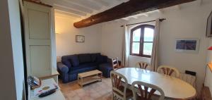 a living room with a blue couch and a table at Appartement 3P Lubéron in Viens